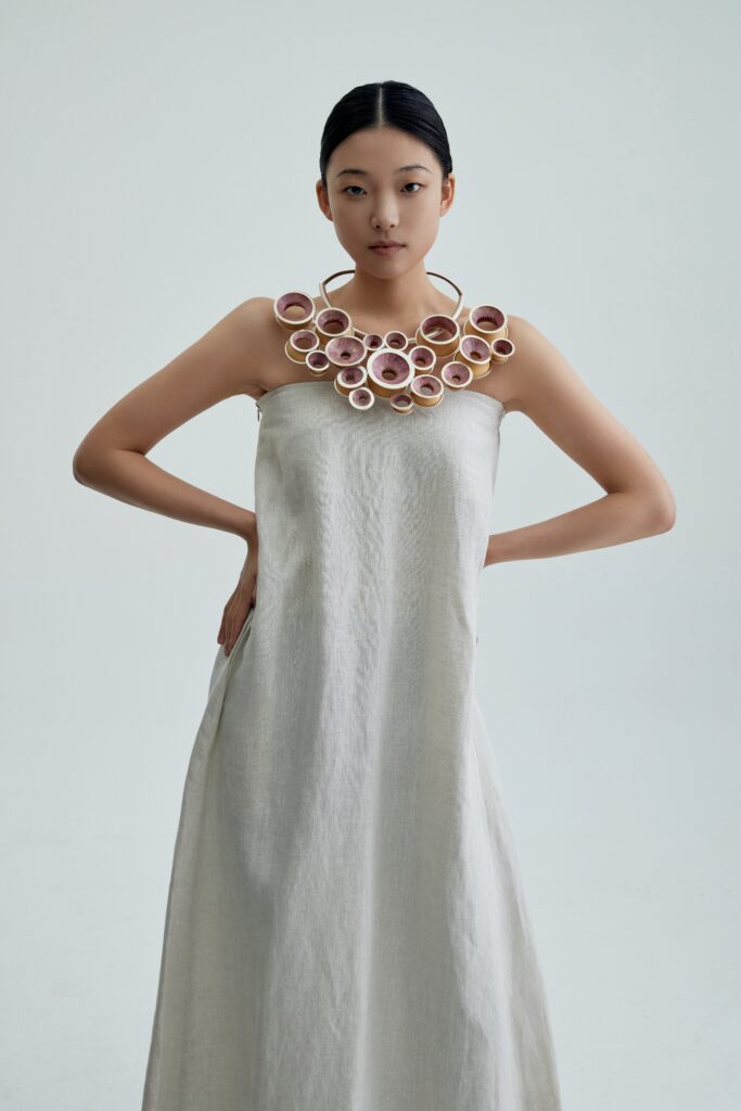 made with sterling silver , cherry blossom petals, gourd, leather