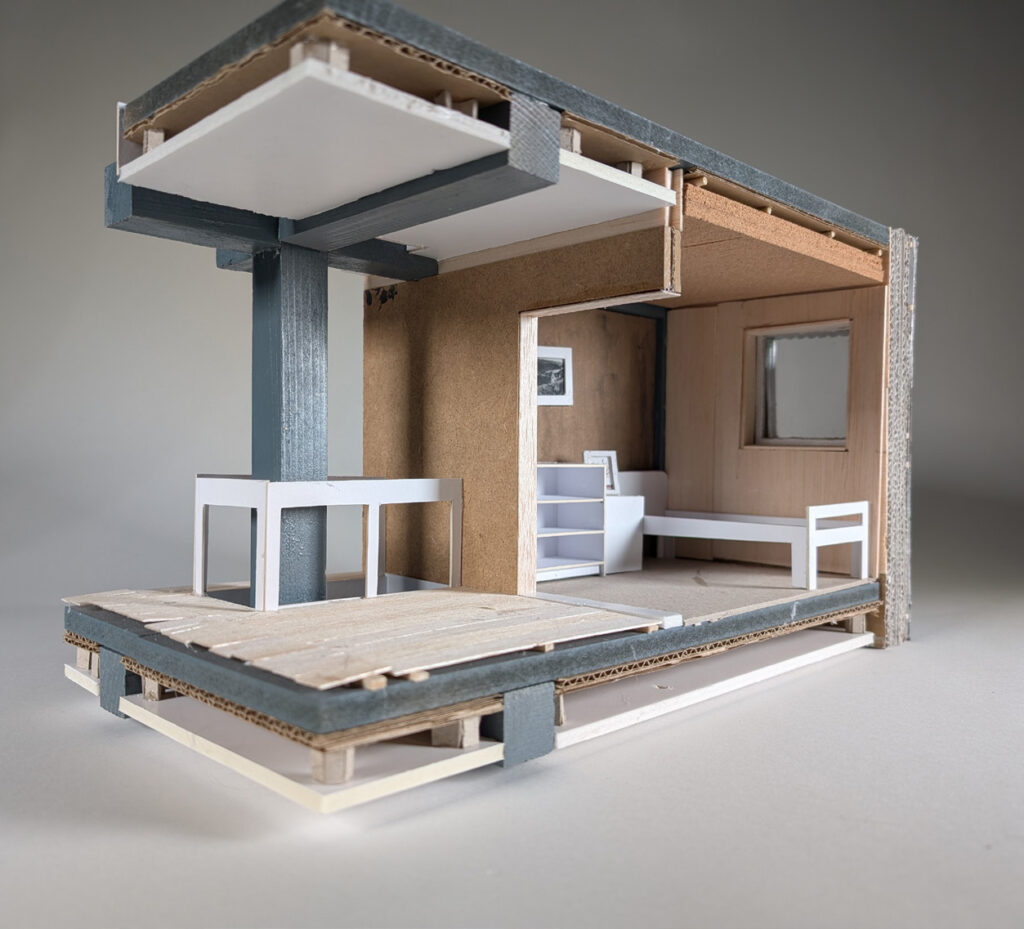 a 1:15 model of a bedroom. The walls are cut through, showing the materials within them