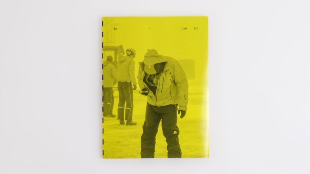Yellow book cover showing a figure in outdoor gear using an avalanche transceiver in a snow-covered environment.