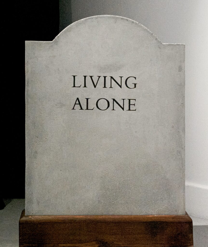 Gravestone reading 'Living Alone'