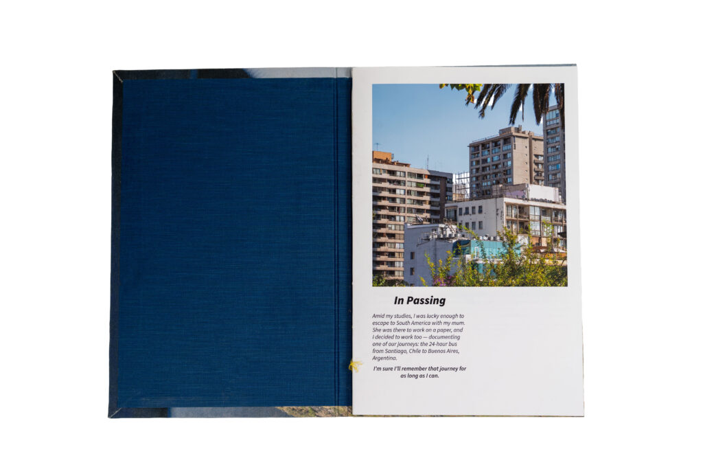 The inside cover of a book shows a framed photograph of a city building in Buenos Aires, viewed from a window, above a short diaristic passage titled “The Other Side.”
