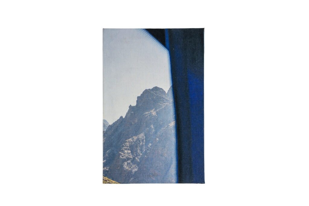 The front cover of the book with a view of a jagged mountain peak framed by the bus window.