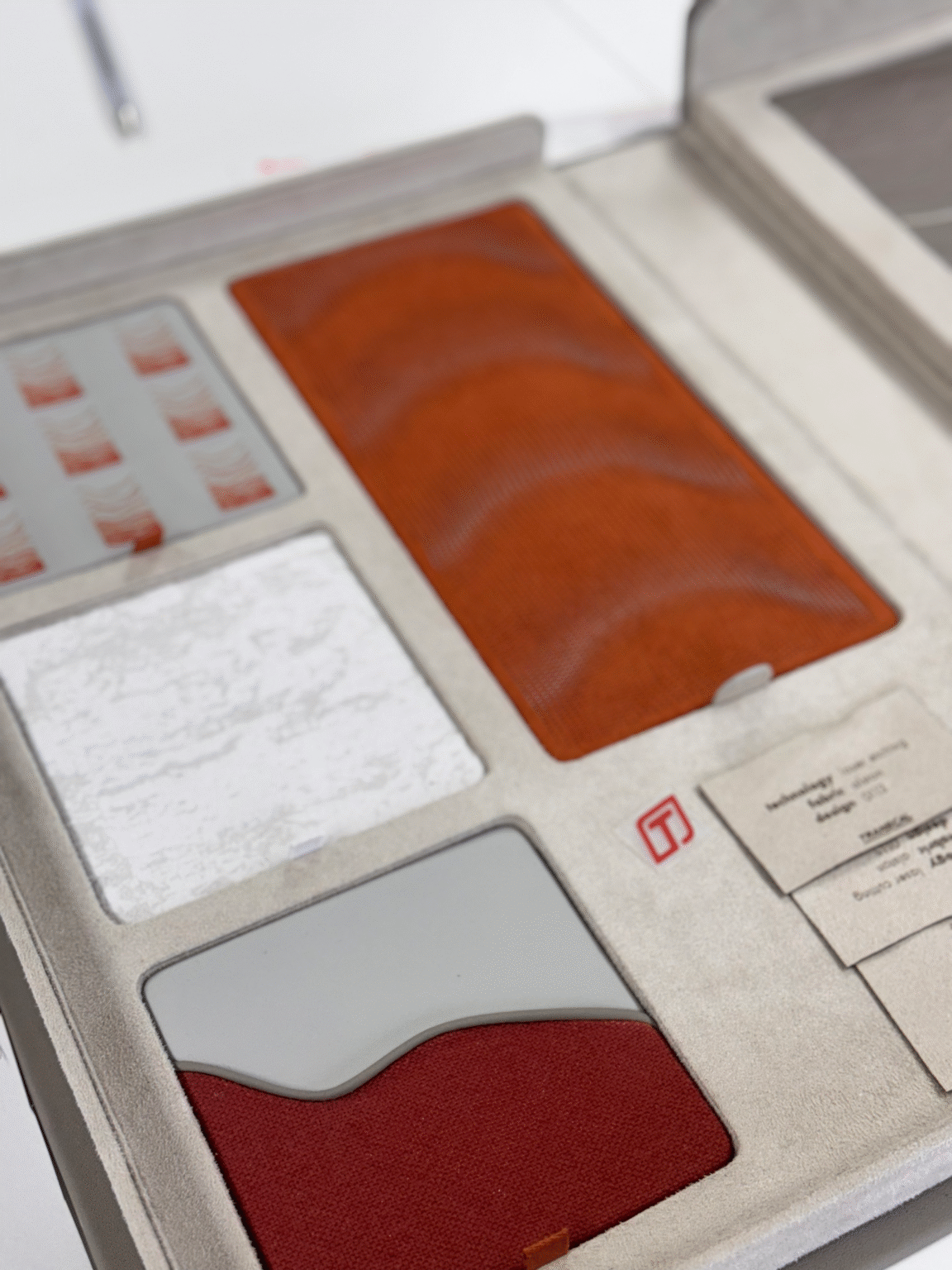 Fully customized CMF box containing material samples that feature digital embroidery with foam, laser etching, and piping trim. The design is inspired by the natural process of decay, translating organic textures into innovative automotive surface treatments.