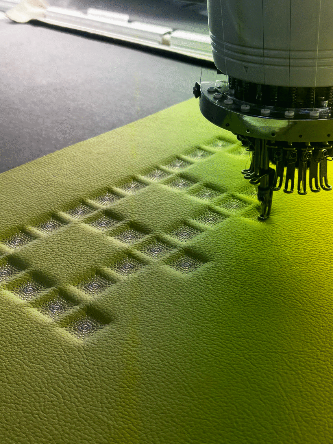 Direct observation and supervision of sample production at the factory level, focusing on digital embroidery to ensure quality control and alignment with automotive CMF standards.